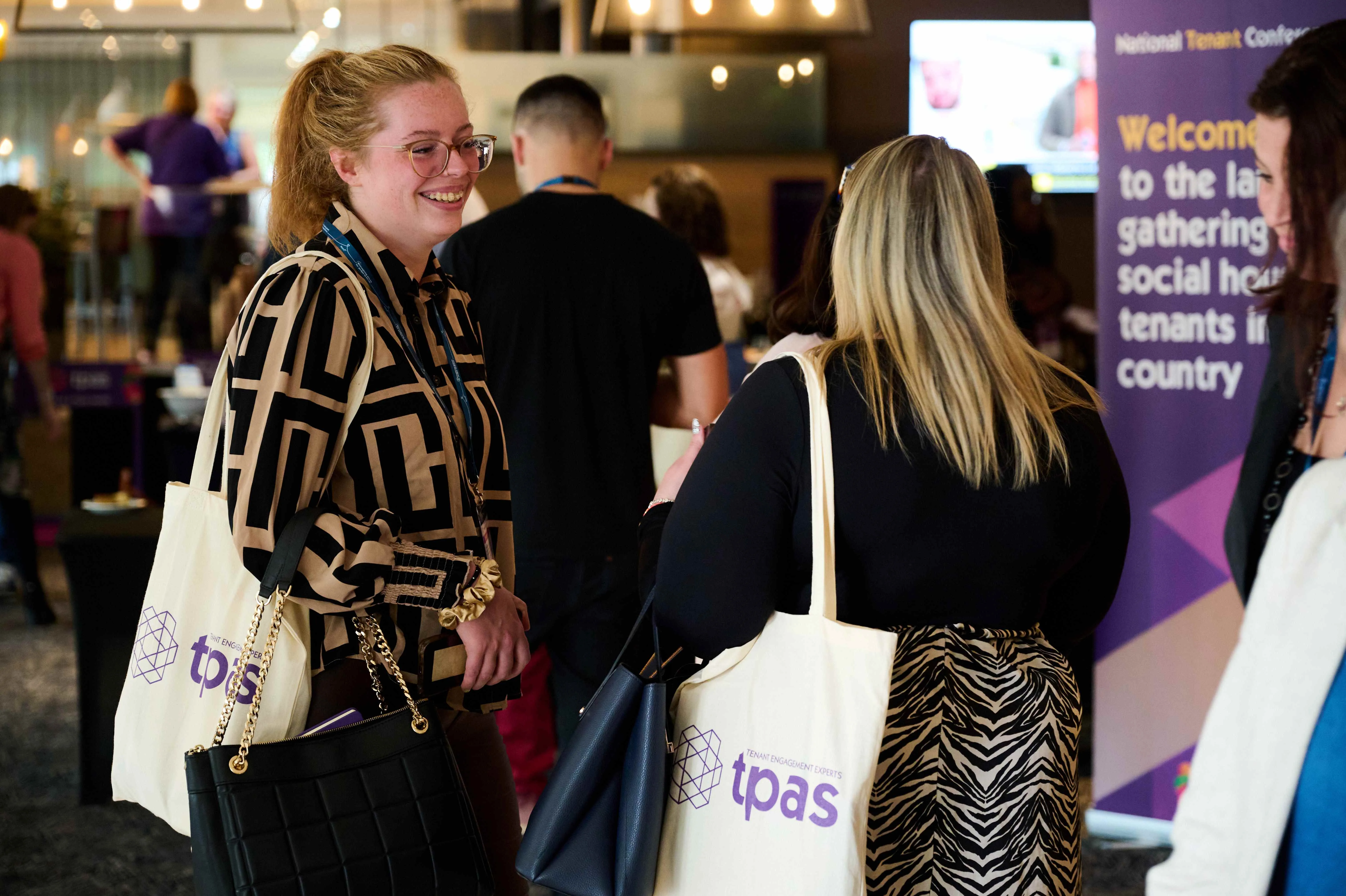 Two people smiling at a Tpas event
